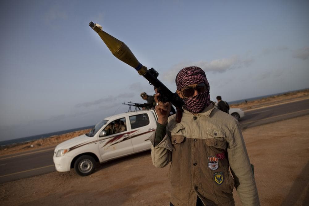 Photojournalist Nicki Sobecki spent a few weeks in Libya documenting the fighting, until her boyfriend and three other New York Times journalists were captured by government military forces. In this photo taken by Sobecki, a fighter carries an RPG launcher on the road outside of Brega in Libya. (Nicki Sobecki/GlobalPost) 
