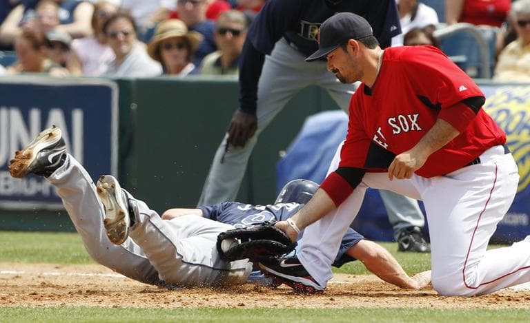 Boston Red Sox first baseman Adrian Gonzalez applies a late tag on an unsuccessful pick off attempt during a spring training game. (AP)