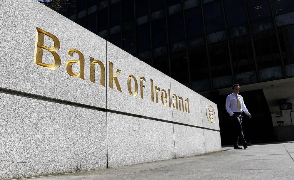 A worker leaves the Bank of Ireland headquarters in central Dublin, Ireland. (AP)