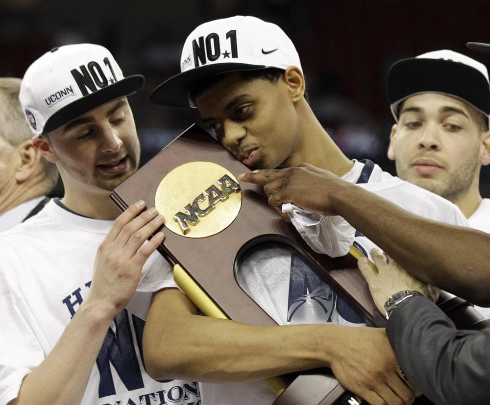 Connecticut&#39;s Jeremy Lamb, center, cradles the trophy after the men&#39;s NCAA Final Four college basketball championship game against Butler on Monday in Houston. (AP)