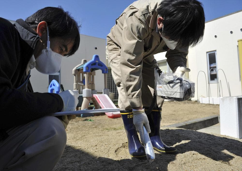 Government employees monitor radiation levels at a day-care center in Iitate, Fukushima prefecture, northern Japan Tuesday. (AP)