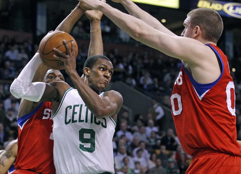Boston Celtics guard Rajon Rondo (9) looks to pass against the defense of Philadelphia 76ers forward Thaddeus Young, left, and center Spencer Hawes, right, during the first half of an NBA basketball game in Boston on Tuesday. (AP)