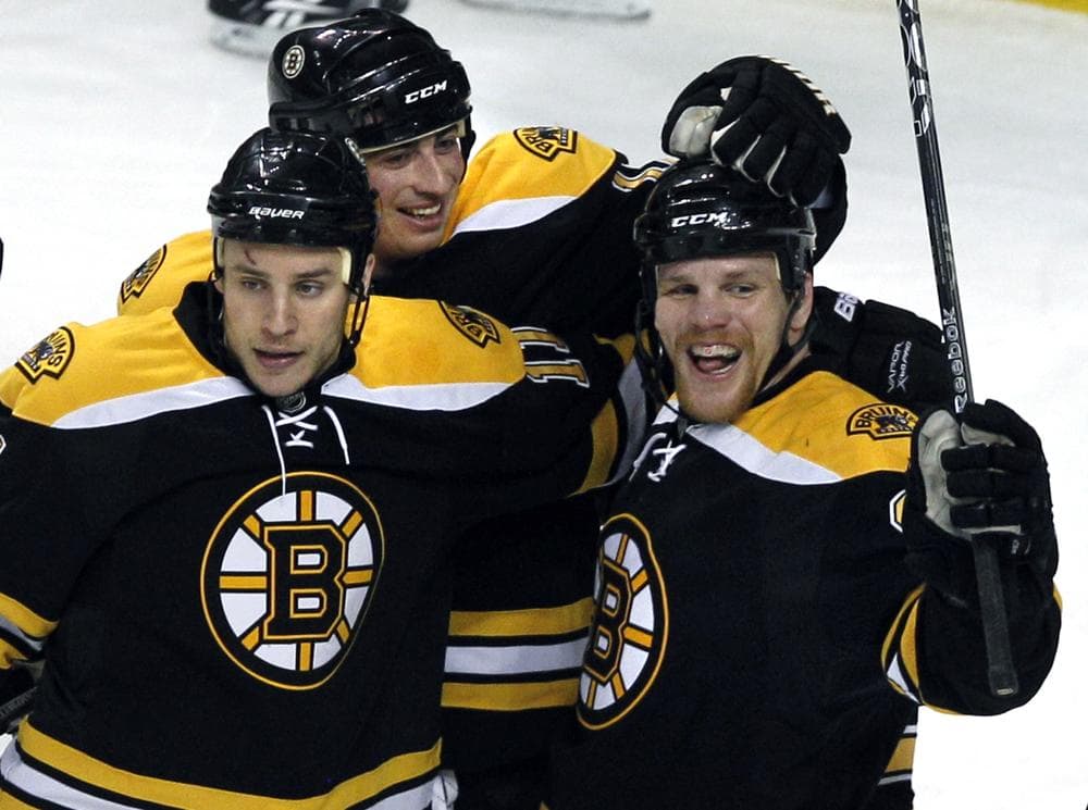 Boston Bruins right wing Shawn Thornton, right, celebrates his goal with teammates Gregory Campbell, left, and Tomas Kaberle, of the Czech Republic, during the first period of the game against the New York Islanders in Boston on Wednesday. (AP)