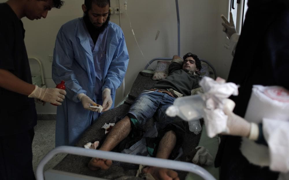 A wounded Libyan rebel fighter is attended by medical staff at the main hospital of Ajdabiya, Libya. (AP)