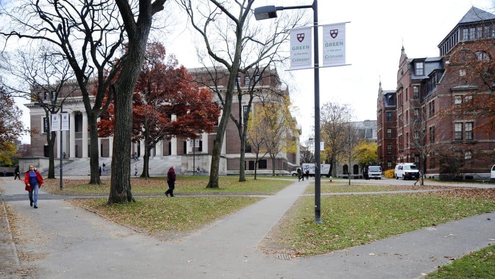 In this file photo, people walk through Harvard Yard at Harvard University, in Cambridge, Mass. (AP)
