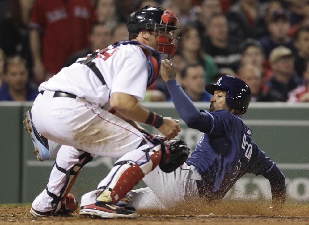 Tampa Bay Rays' B.J. Upton, right, scores on a double by John Jaso as Boston Red Sox catcher Jarrod Saltalamacchia waits for the ball during the fifth inning of a baseball game in Boston on Monday. (AP)