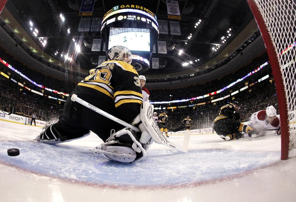 Bruins goalie Tim Thomas looks back as a shot by Montreal Canadiens' Mike Cammalleri, right, goes in for a goal during the first period of Montreal's 3-1 win in Game 2 in Boston Saturday. (AP)