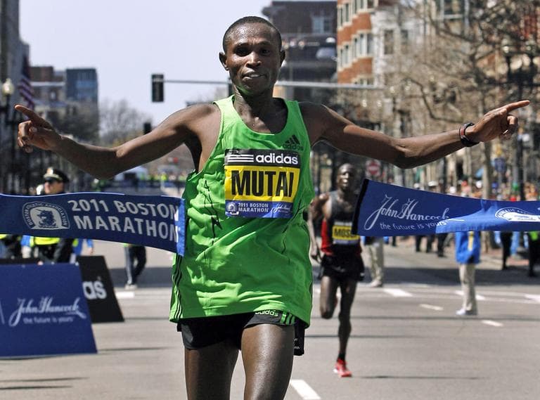 Kenya's Geoffrey Mutai crosses the finish line of the 2011 Boston marathon with a time of 2:03:02. (AP)