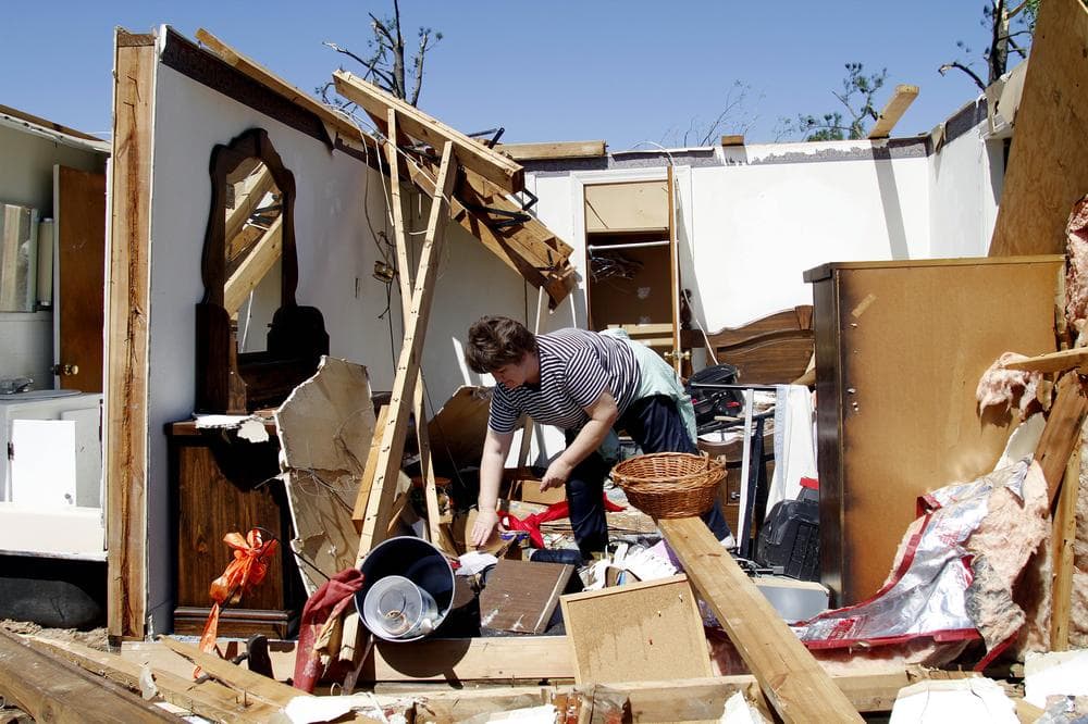 Deborah Dulow cleans up her father's house in Askewville, N.C., after a tornado moved through the area Saturday. (AP)