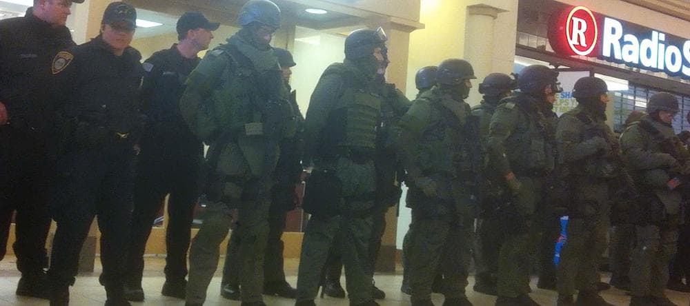 In this cell phone image, SWAT team members and local police line up in the Burlington Mall as it&#039;s searched. (Courtesy)