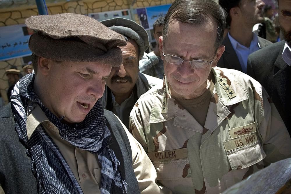 In this July 15, 2009 photo, author Greg Mortenson shows the locations of future village schools to U.S. Navy Adm. Mike Mullen. (AP/Department of Defense)