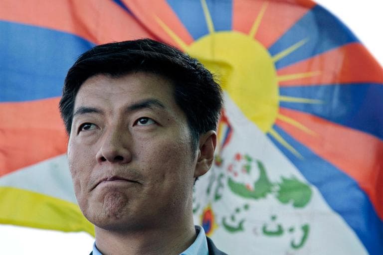 Lobsang Sangay talks in front of a Tibetan flag in Dharamsala, India, on March 20. (AP)