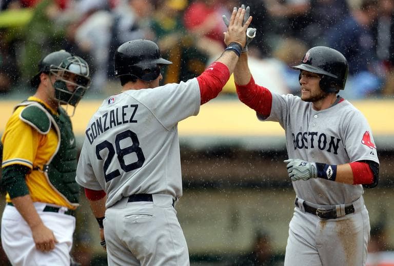 Boston Red Sox shortstop Jed Lowrie, right, is congratulated by Adrian Gonzalez following his home run against the Oakland Athletics on Wednesday afternoon. (AP)