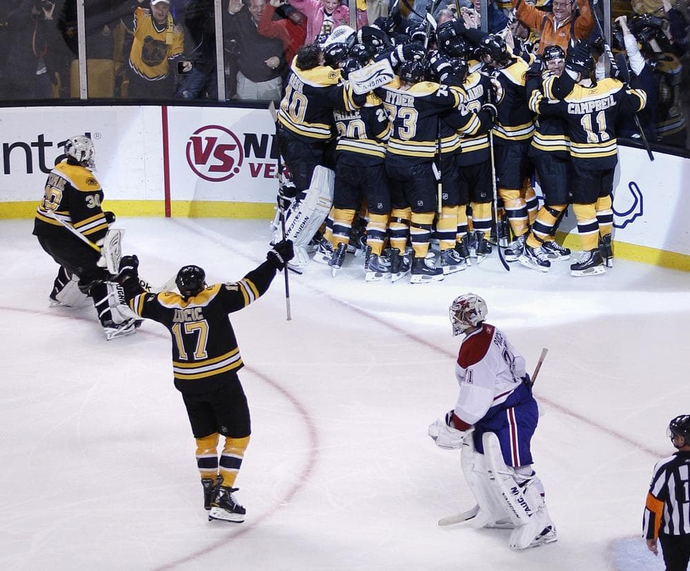 Canadiens goalie Carey Price, bottom right, skates off the ice as the Boston Bruins surround Nathan Horton after he scored the game-winning goal during the second overtime period in Game 5 in Boston, Saturday.  (AP)