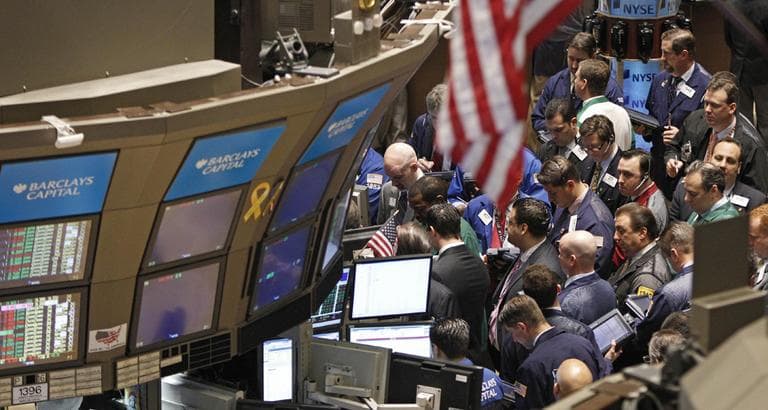 Traders react on the floor of the New York Stock Exchange April 19. (AP)