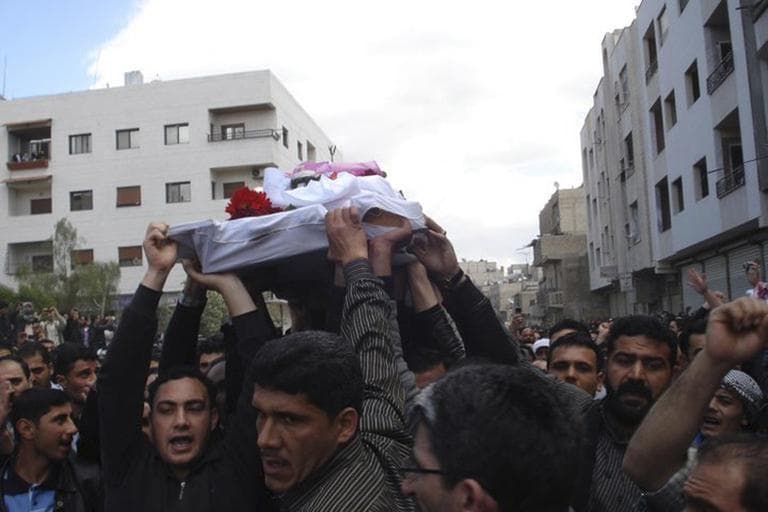 In this citizen journalism image made on a mobile phone, Syrian anti-government protesters carry the coffin of an activist who was killed in Quaboun near Damascus, Syria, April 23.