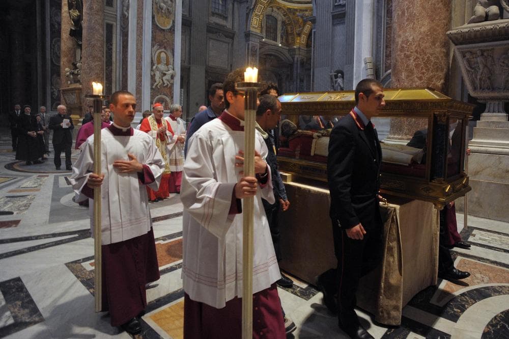 In this photo provided by the Vatican newspaper L'Osservatore Romano, the remains of holy Innocenzo XI are moved inside St. Peter's basilica to make room for those of late Pope John Paul II, ahead of the beatification ceremony scheduled for Sunday, May 1. (AP/L'Osservatore Romano) 