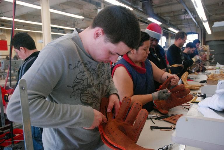 An Insignia worker builds a glove from scratch. (Jesse Costa/WBUR)