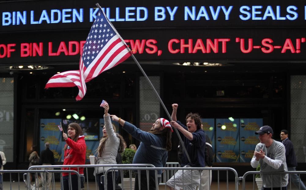 Melissa LaCour, left, Brittany McGarry, second from left, Bryan Murray, second from right, and Dennis Vincent celebrate outside the ABC studio in New York's Times Square as news of Osama bin Laden's death is announced on the ticker. (AP)