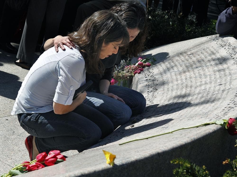 Sisters Carie, left, and Danielle Lemack, whose mother Judy Larocque died on Flight 11 from Logan Airport on 9/11, grieve in Boston Monday, at the Garden of Remembrance. (AP)