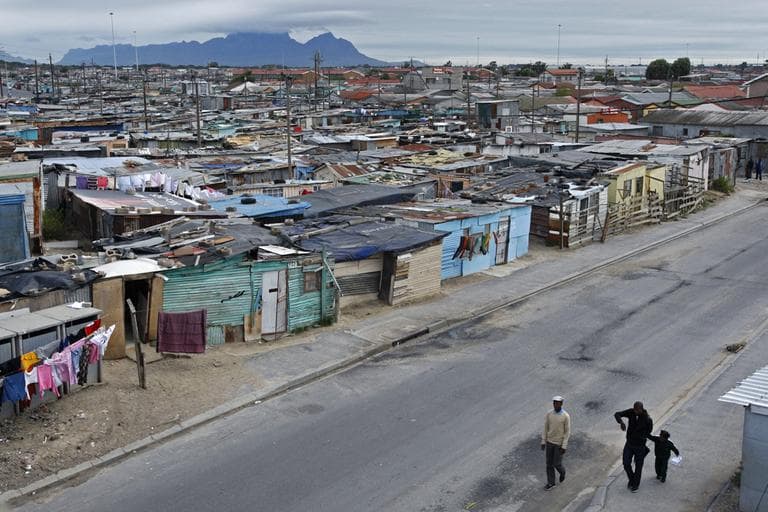 People walk in the impoverished township of Khayelitsha situated on the outskirts of Cape Town, South Africa. (AP)
