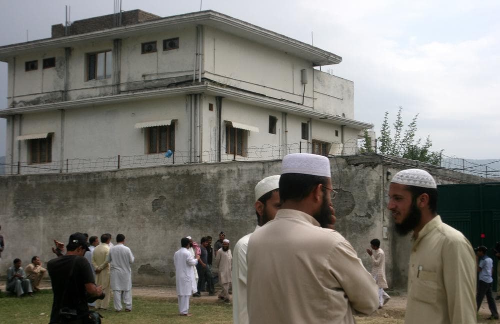 Local residents and media persons stand outside the house of  where al-Qaida leader Osama bin Laden was caught and killed in Abbottabad, Pakistan. (AP) 