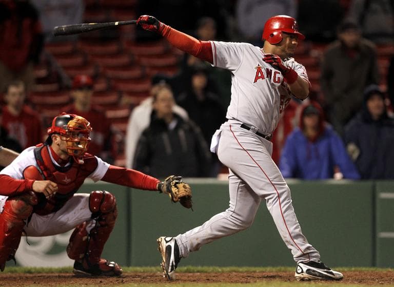 Los Angeles Angels' Bobby Abreu hits a two-run single off a pitch by Boston's Daisuke Matsuzaka as Red Sox catcher Jason Varitek looks on during the 13th inning at Fenway Park in Boston early Thursday. (AP)