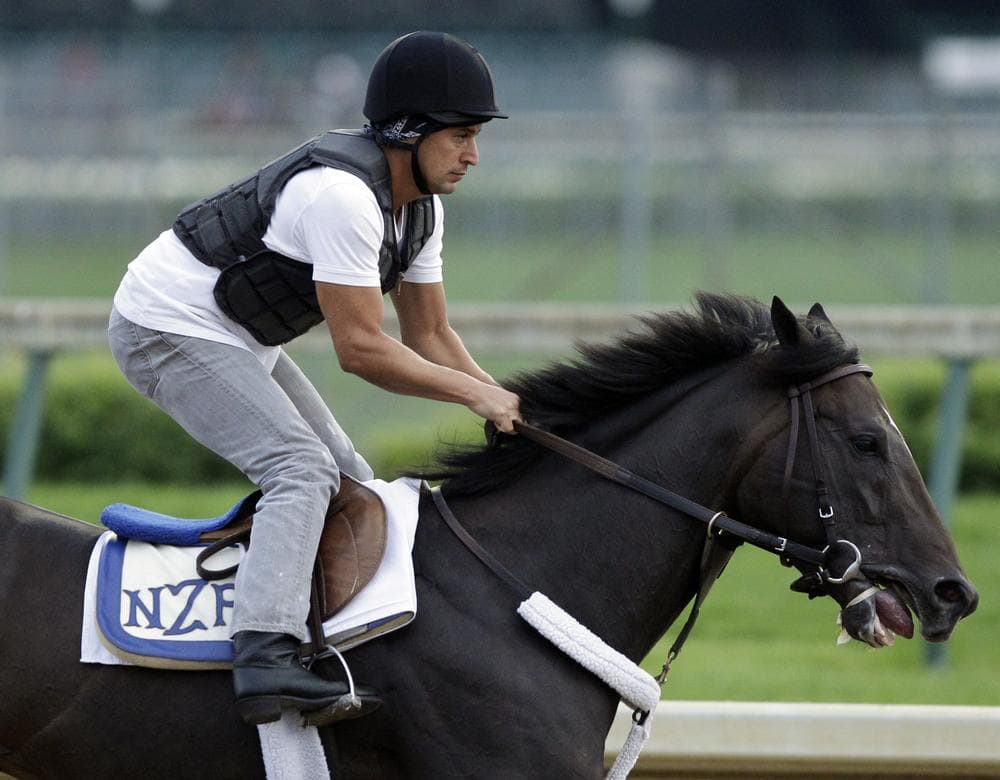 Exercise rider Carlos Correa takes Kentucky Derby entrant Dialed In for a workout at Churchill Downs Friday, May 6, 2011, in Louisville, Ky. (AP)