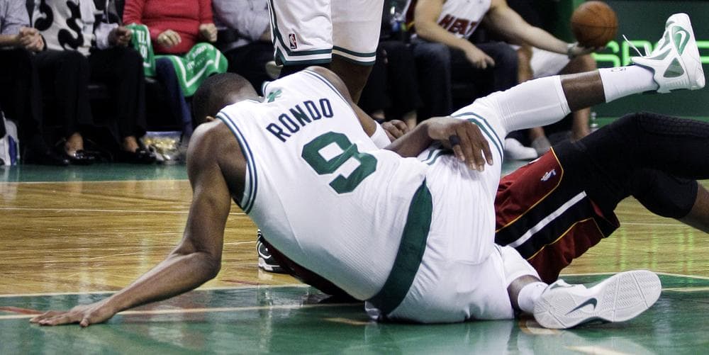 The left elbow of Boston Celtics guard Rajon Rondo dislocates as he tangles with Miami Heat guard Dwyane Wade. (AP) 