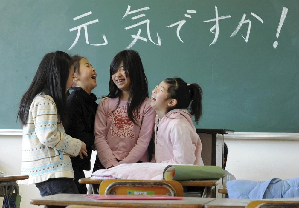 Elementary school children share a chuckle as they reunite for the first time since the March 11 earthquake at Masuda Nishi elementary school in Natori, Miyagi Prefecture, northern Japan. The words on the blackboard read &quot;How have you been doing?&quot; (AP)