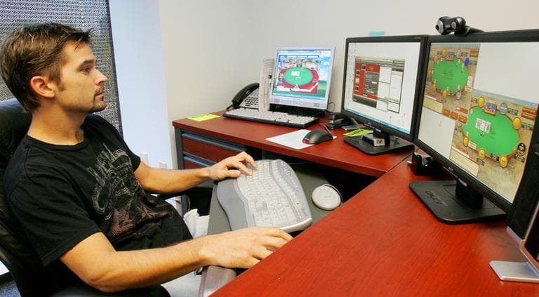 Jeff Markley, an online media executive, peruses Full Tilt, Bodog and Poker Stars online on three screens in his office in Atlanta, in October of 2006. (AP)