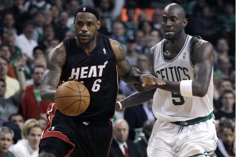 Miami Heat forward LeBron James gets past Boston Celtics forward Kevin Garnett during overtime of Game 4. (AP)