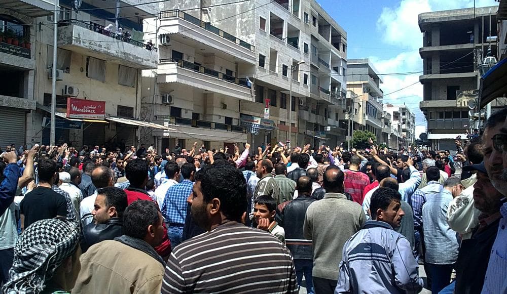 In this citizen journalism image made on a mobile phone and acquired by the AP, Syrian anti-government protesters shout slogans as they gather in the coastal town of Banias, Syria, Friday, May 6, 2011. (AP)