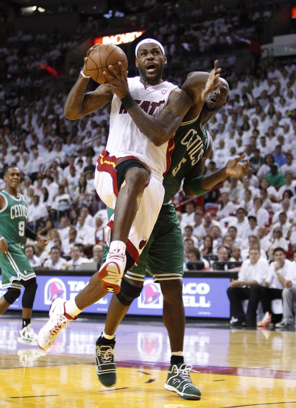 Miami Heat's LeBron James goes up for a shot against Boston Celtics' Kevin Garnett (5) during Game 5 of an NBA playoff basketball series, Wednesday, May 11, 2011 in Miami. (AP)