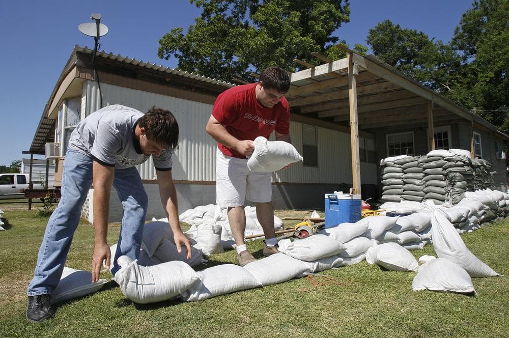 Ty Fontenot, left, and his brother Aron build a wall of sand bags around their home in Krotz Springs, La., Sunday in advance of forecasted flooding of the Mississippi river brought on by the opening of the Morganza Spillway north of town. (AP)