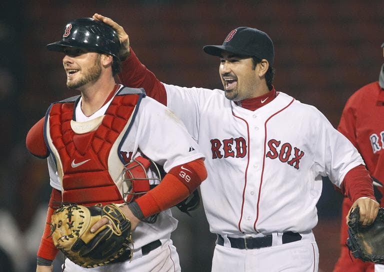 Boston Red Sox&#039;s Adrian Gonzalez, right, pats Jarrod Saltalamacchia on the helmet after the game in Boston, Wednesday. (AP)