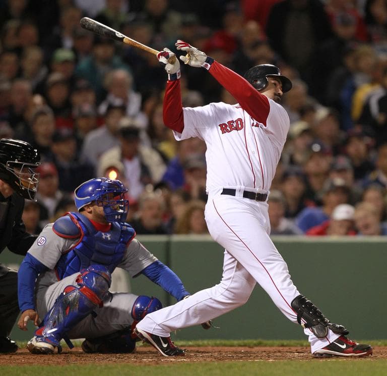 Boston Red Sox's Adrian Gonzalez, right, follows through on a double in front of Chicago Cubs' Welington Castillo in the fifth inning of an interleague baseball game at Fenway Park in Boston, Sunday. The Red Sox won 5-1. (AP)