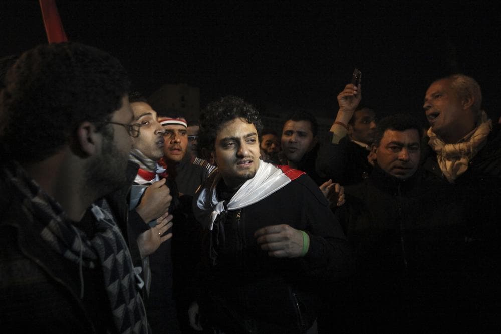 Egyptian Wael Ghonim, center, the 30-year-old Google Inc. marketing manager who was a key organizer of the online campaign that sparked the first protest on Jan. 25, walks into Tahrir Square after Egyptian President Hosni Mubarak's televised statement to his nation, in downtown Cairo, Egypt. (AP)