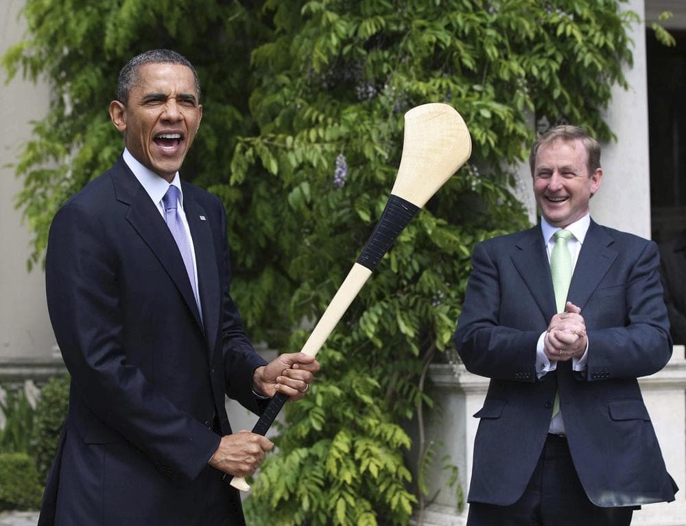 President Obama reacts after he was presented with a hurley stick from Irish Prime Minister Enda Kenny while in Dublin, Ireland, Monday. (AP)