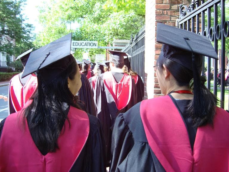Graduates walk at Harvard's Commencement exercises. (linoleum jet/Flickr)