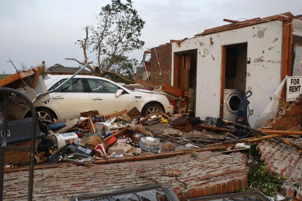 A car sits in what used to be the garage of a brick home in Piedmont, Okla., following a tornado, Tuesday, May 24, 2011. (AP)
