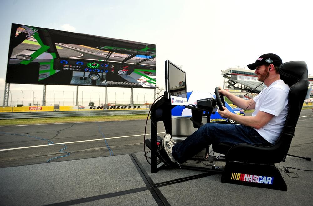 NASCAR driver Dale Earnhardt, Jr. plays video games on the new screen at Charlotte Motor Speedway. (AP)