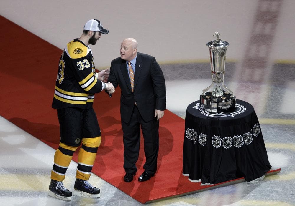 NHL deputy commissioner Bill Daly, right, presents the Prince of Wales Trophy to Zdeno Chara in Boston, Friday. (AP)