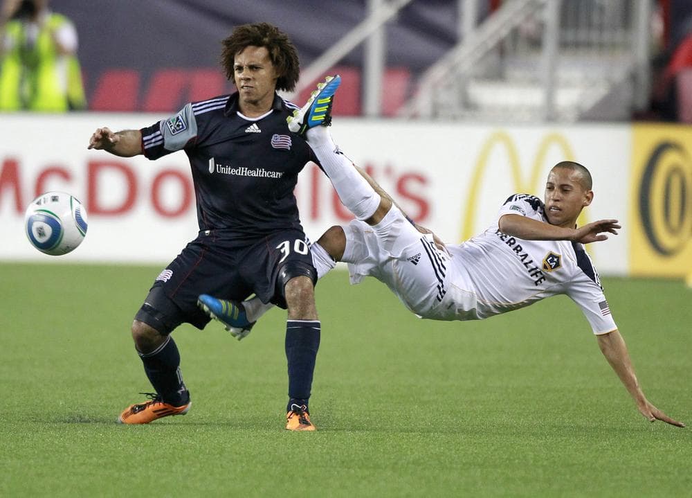 Los Angeles Galaxy&#039;s Paolo Cardozo, right, kicks the ball away from New England Revolution&#039;s Kevin Alston in the second half on Saturday in Foxborough. (AP)