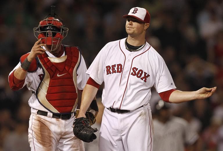 Boston Red Sox catcher Jarrod Saltalamacchia looks down as starting pitcher Jon Lester reacts to giving up a two-run single to the White Sox on Monday. (AP)