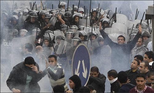 Activists clash with riot police in Cairo. (AP)