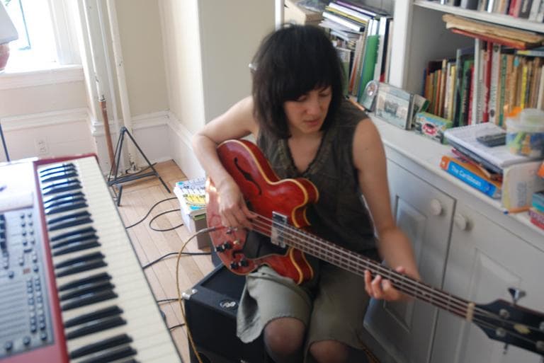Naomi Yang plays her beloved bass. (Andrea Shea/WBUR)