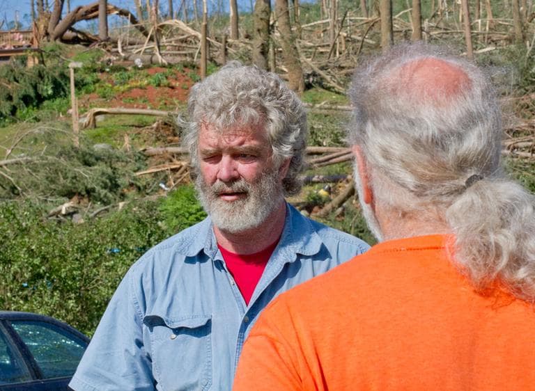Stephen Phifer, left, speaks to neighbor Dennis Keough about his ordeal with the tornado. (Jesse Costa/WBUR)