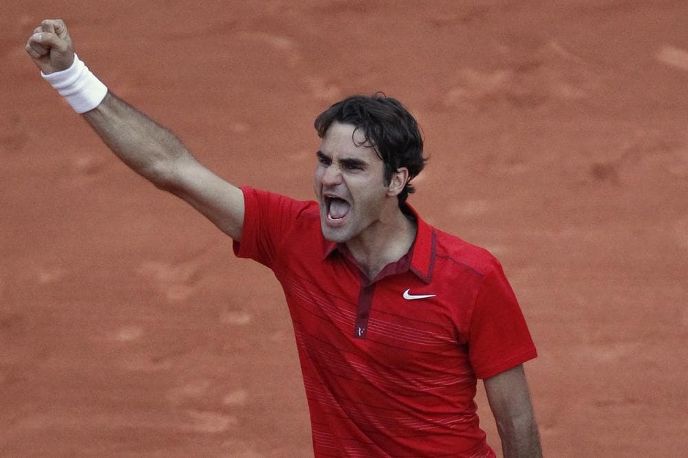 Roger Federer celebrates his victory over Novak Djokovic in the semi final match of the French Open Paris on Friday. (AP)