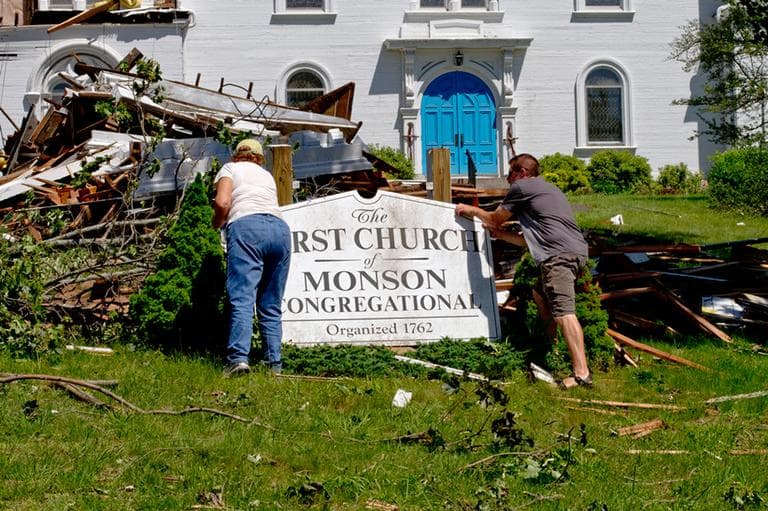 Volunteers begin cleaning up the area around the First Church of Monson. (Jesse Costa/WBUR)